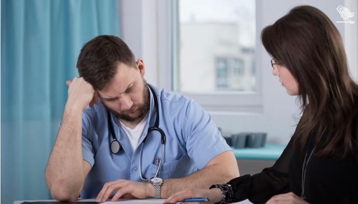 Doctor sitting with lawyer